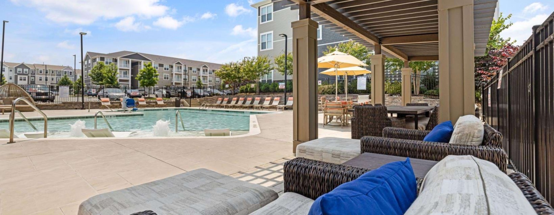 a pool with chairs and a deck